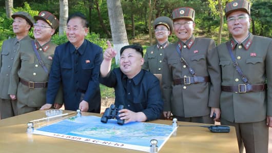 Image result for Photos released showing Kim Jong Un guiding Missile test