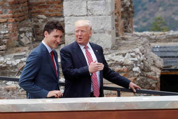 Canadian Prime Minister Justin Trudeau (L) and U.S. President Donald Trump talk as they arrive for a family photo, during the G7 Summit in Taormina, Sicily, Italy, May 26, 2017.