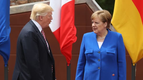 German Chancellor Angela Merkel and U.S. President Donald Trump arrive for the group photo at the G7 Taormina summit on t