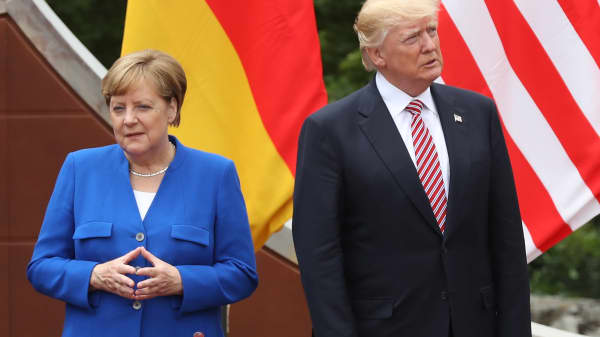 German Chancellor Angela Merkel and U.S. President Donald Trump arrive for a group photo at a G7 summit on May 26, 2017 in Taormina, Italy.