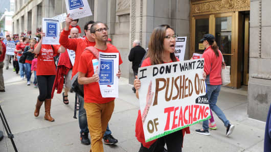 Chicago Teachers Union employees and supporters protest outside of City Hall in Chicago, on July 2, 2015.