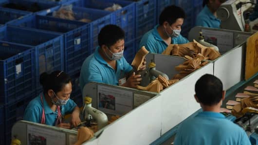 Workers on a production line at a shoe factory in Dongguan, Guangdong province in China on Sept. 14, 2016.