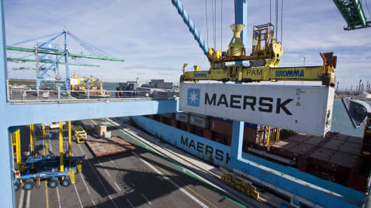 A crane loads a shipping container branded AP Moller-Maersk A/S onto the freight ship. The company fell victim to a widespread cyberattack on June 27, 2017.