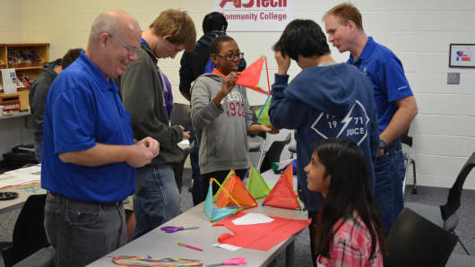 GE employees try to spark kids' interest in science, tehnology, engineering and math at the GE Asheville career day event at Asheville–Buncombe Tech Community College in North Carolina