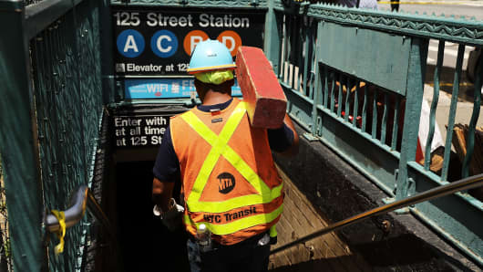 A Metropolitan Transportation Authority worker enters a Harlem subway station where a morning train derailment occurred on June 27, 2017, in New York City.