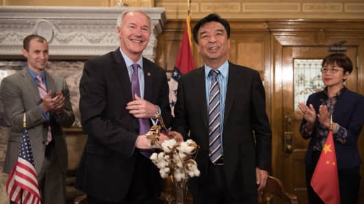 Arkansas Gov. Asa Hutchinson with Qiu Yafu, chairman of Shandong Ruyi Group, a textile company that created 800 additional jobs in Forrest City.
