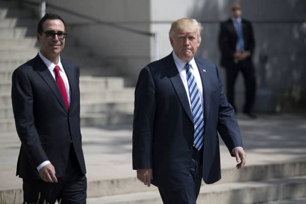 President Donald Trump (R) and Treasury Secretary Steven Mnuchin walk out of the Treasury building, April 21, 2017.