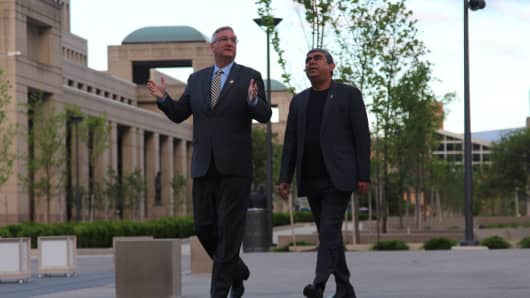 Indiana Gov. Eric Holcomb and Infosys CEO Vishal Sikka tour the grounds of the Indiana Statehouse.