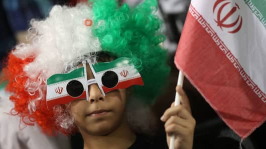 An Iranian fan waves his national flag during a World Cup 2018 Asia qualifying football match between Qatar and Iran at the Jassim Bin Hamad stadium in Doha on March 23, 2017