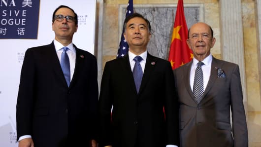 U.S. Treasury Secretary Steve Mnuchin (L), Commerce Secretary Wilbur Ross (R) and China's Vice Premier Wang Yang pose for a family photo before the U.S. - China Comprehensive Economic Dialogue to discuss bilateral economic and trade issues in Washington, U.S., July 19, 2017.