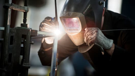 An employee welds a specialized metal product in the shop at the Amuneal Manufacturing Corp. plant in Philadelphia, Pennsylvania.