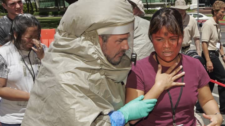 File photo of an ER tech escorting a victim of a mock nuclear blast into the decontamination tent during a disaster drill at Queen's Medical Center in Honolulu, Hawaii.