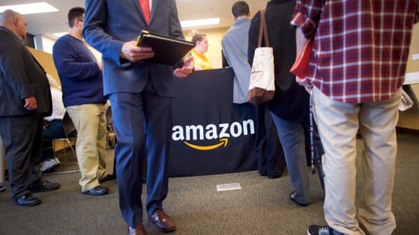 Job seekers register before interviews during an Amazon jobs fair at the Amazon Fulfillment Center in Robbinsville, New Jersey.