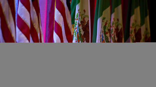 American flags, left, stand next to Mexican flags ahead of the first round of North American Free Trade Agreement (NAFTA) renegotiations in Washington, D.C., U.S., on Wednesday, Aug. 16, 2017.