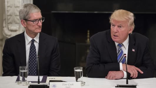 President Donald Trump, right, speaks as Tim Cook, CEO of Apple, listens during the American Technology Council roundtable hosted at the White House in Washington, D.C.