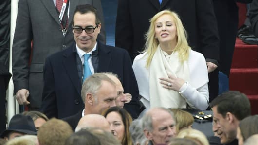 Donald Trump's Treasury nominee Steven Mnuchin and his wife Louise Linton on the platform of the US Capitol in Washington, DC, on January 20, 2017, at the swearing-in ceremony of President Donald Trump.