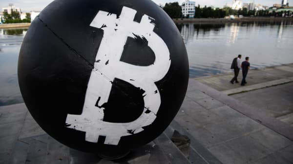 The Bitcoin cryptocurrency symbol on a stone sphere monument painted black by unidentified persons in Oktyabrskaya Square in Yekaterinberg, Russia.