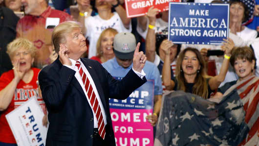 President Donald Trump gestures to the crowd of supporters at the Phoenix Convention Center as he takes the stage during a rally on August 22, 2017 in Phoenix, Arizona.