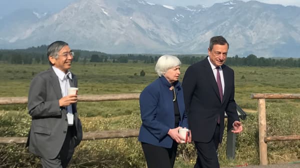 Governor of the Bank of Japan Haruhiko Kuroda (L to R), United States Federal Reserve Chair Janet Yellen and President of the European Central Bank Mario Draghi walk after posing for a photo opportunity during the annual central bank research conference in Jackson Hole, Wyoming, August 25, 2017.