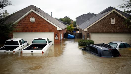 Houses and vehicles at the Highland Glen subdivision stand in floodwaters due to Hurricane Harvey in Spring, Texas, U.S., on Monday, Aug. 28, 2017.