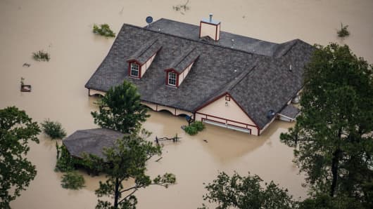 A house sits completely submerged in flood water in the wake of Hurricane Harvey in Houston, Texas, on Aug. 29, 2017.