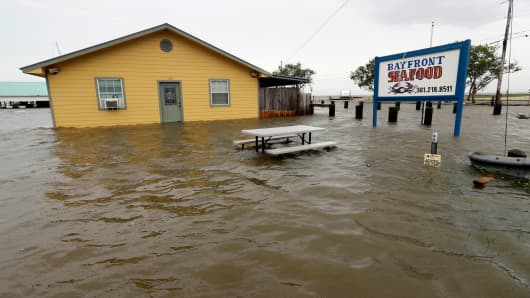 The Bayfront Seafood restaurant is surrounded by floodwaters in the aftermath of Hurricane Harvey Saturday, Aug. 26, 2017, in Palacios, Texas.