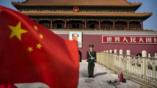 A Chinese soldier stands guard in front of Tiananmen Gate outside the Forbidden City in Beijing.