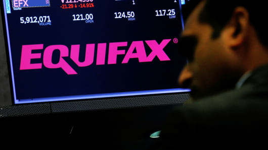 Equifax trading information and the company logo are displayed on a screen where the stock is traded on the floor of the New York Stock Exchange in New York.