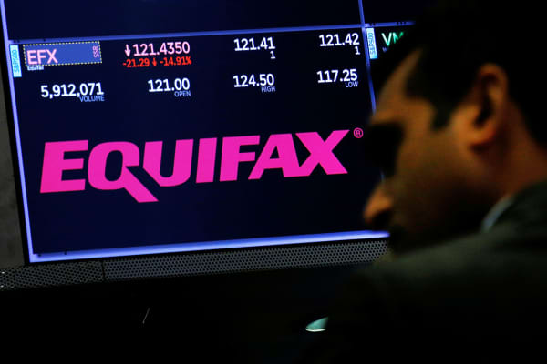Equifax trading information and the company logo are displayed on a screen where the stock is traded on the floor of the New York Stock Exchange in New York.