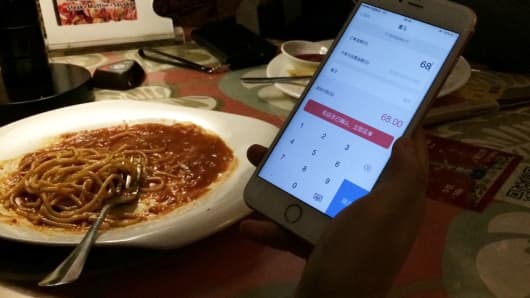 After scanning the QR code on the table at this restaurant in Beijing, China, customers enter the payment amount in the app.