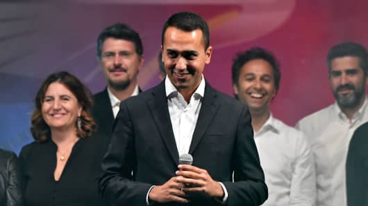 Lower House Deputy speaker Luigi Di Maio (C) stands on stage after being chosen the Five Star Movement (M5S) candidate for Prime minister during a M5S party's congress in Rimini on September 23, 2017.