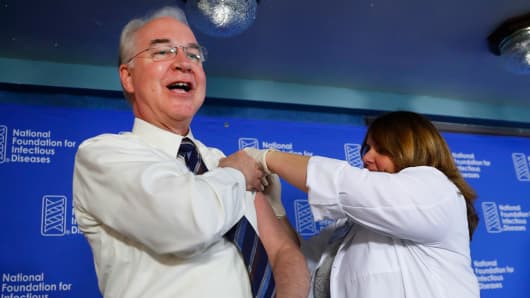 Health and Human Services Secretary Tom Price, left, receives a flu vaccination from Sharon Walsh-Bonadies, RN., right, during a news conference recommending everyone age six months an older be vaccinated against influenza each year, Thursday, Sept. 28, 2017 in Washington.