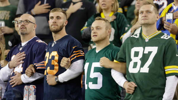 Fans lock arms during the national anthem before an NFL football game between the Green Bay Packers and the Chicago Bears Thursday, Sept. 28, 2017, in Green Bay, Wis.