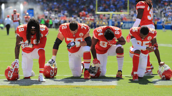 Terrance Smith #48, Eric Fisher #72, Demetrius Harris #84, and Cameron Erving #75 of the Kansas City Chiefs is seen taking a knee before the game against the Los Angeles Chargers at the StubHub Center on September 24, 2017 in Carson, California.