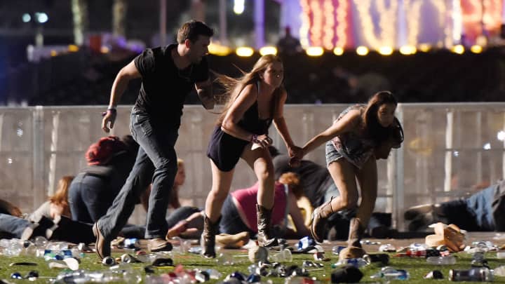 People run from the Route 91 Harvest country music festival after apparent gun fire was hear on October 1, 2017 in Las Vegas, Nevada.
