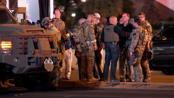 FBI agents confer in front of the Tropicana hotel-casino on October 2, 2017, after a mass shooting during a music festival on the Las Vegas Strip in Las Vegas, Nevada.