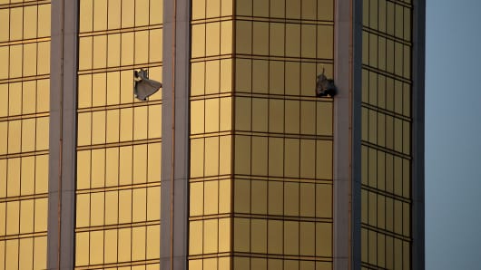 Drapes billow out of broken windows at the Mandalay Bay resort and casino Monday, Oct. 2, 2017, on the Las Vegas Strip following a deadly shooting at a music festival in Las Vegas. A gunman was found dead inside a hotel room.