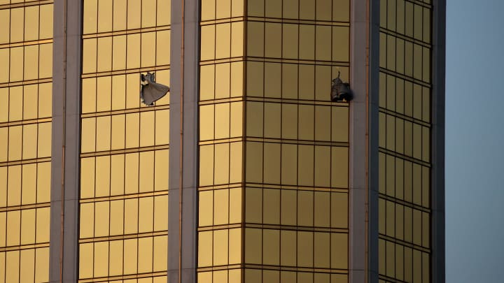 Drapes billow out of broken windows at the Mandalay Bay resort and casino Monday, Oct. 2, 2017, on the Las Vegas Strip following a deadly shooting at a music festival in Las Vegas. A gunman was found dead inside a hotel room.
