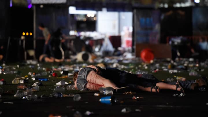 A person lies on the ground covered with blood at the Route 91 Harvest country music festival after apparent gun fire was heard on October 1, 2017 in Las Vegas, Nevada.