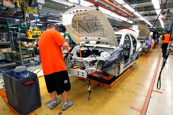 A General Motors' worker assembles a Cadillac ATS on the assembly line at the General Motors Lansing Grand River Assembly Plant.