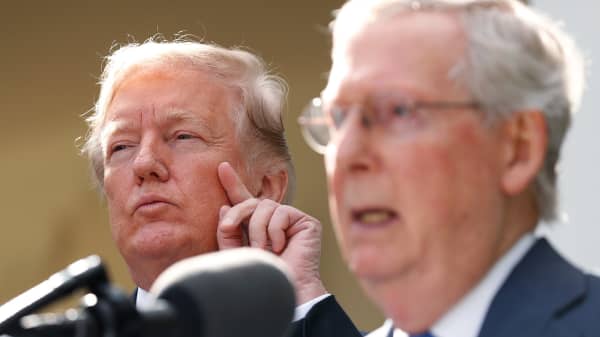 President Donald Trump listens as Senate Majority Leader Mitch McConnell speaks to the media in the Rose Garden of the White House in Washington, U.S., October 16, 2017.