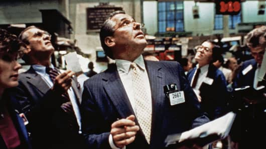In this Oct. 19, 1987 file photo, traders on the floor of the New York Stock Exchange watch monitors for transactions.
