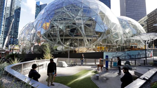 In this photo taken Oct. 11, 2017, large spheres take shape in front of an existing Amazon building and adjacent to a small dog park in Seattle.