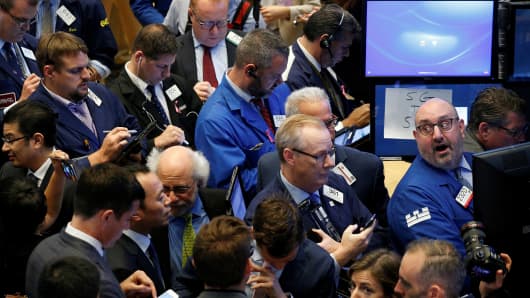Traders gather for the IPO of Singapore-based Sea Limited on the floor of the New York Stock Exchange (NYSE) in New York, U.S., October 20, 2017.