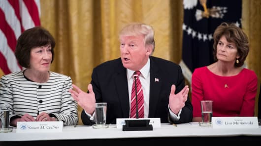 President Donald Trump, center, speaks as he meets with Republican senators about health care in the East Room of the White House of the White House in Washington, DC on Tuesday, June 27, 2017. Seated with him are Sen. Susan Collins, R-Maine, left, and Sen. Lisa Murkowski, R-Alaska, right.