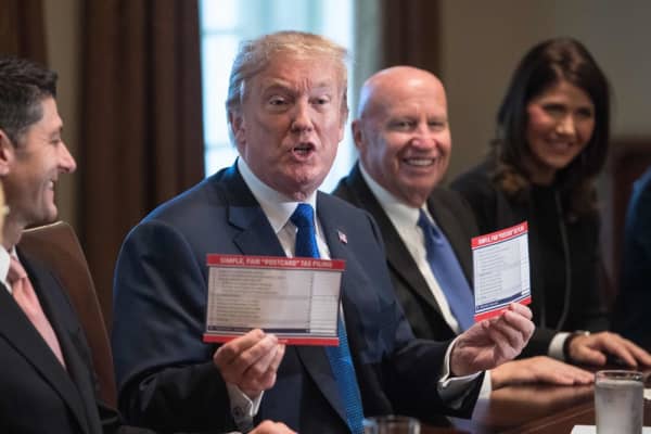 President Donald Trump shows samples of the proposed new tax form at the White House in Washington, DC, on November 2, 2017.