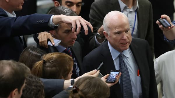 Sen. John McCain (R-AZ) talks to reporters as he walks to the Senate chamber.