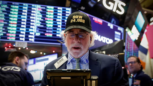 Trader Peter Tuchman works on the floor of the New York Stock Exchange, (NYSE) as the Dow Jones Industrial Average crosses 24,000, in New York, U.S., November 30, 2017.