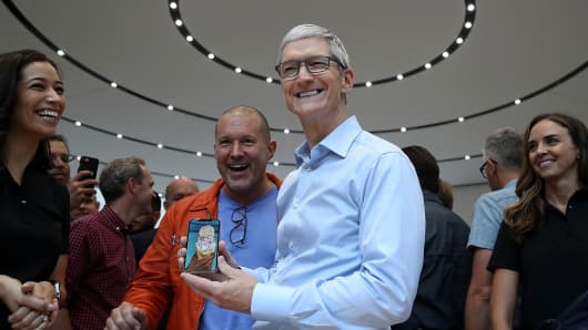 Apple CEO Tim Cook (R) and Apple chief design officer Jonathan Ive (L) look at the new Apple iPhone X during an Apple special event at the Steve Jobs Theatre on the Apple Park campus on September 12, 2017 in Cupertino, California.