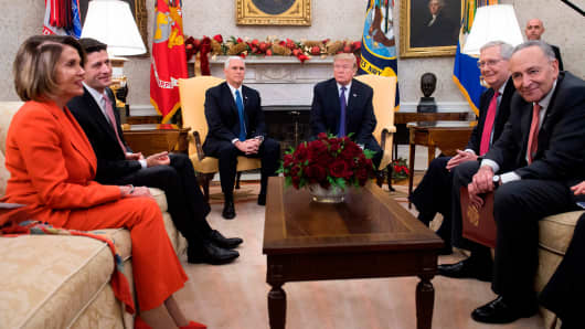 President Donald Trump, alongside Vice President Mike Pence (3rd L), meets with Congressional leadership including Senate Majority Leader Mitch McConnell (2nd R), Republican of Kentucky, Senate Minority Leader Chuck Schumer (R), Democrat of New York, Speaker of the House Paul Ryan (2nd L), Republican of Wisconsin, and House Democratic Leader Nancy Pelosi (L), Democrat of California, in the Oval Office at the White House in Washington, DC, December 7, 2017.
